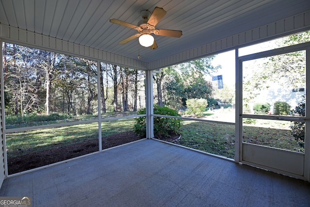 unfurnished sunroom with ceiling fan