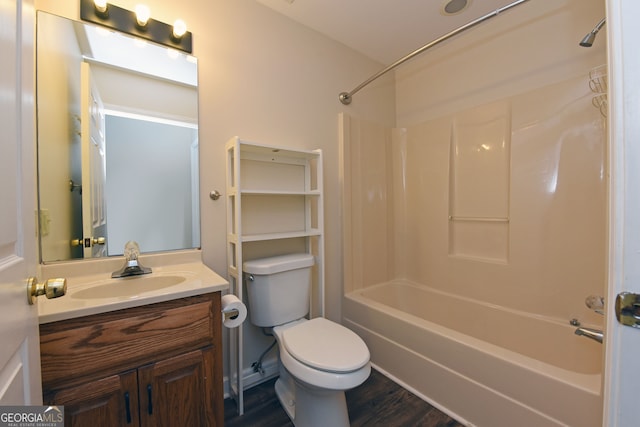 full bathroom with vanity, toilet, hardwood / wood-style flooring, and tub / shower combination