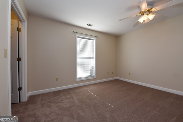 carpeted spare room with ceiling fan