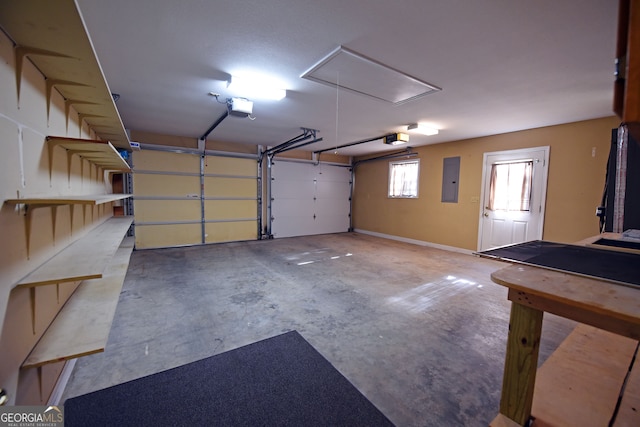 garage with a garage door opener and electric panel