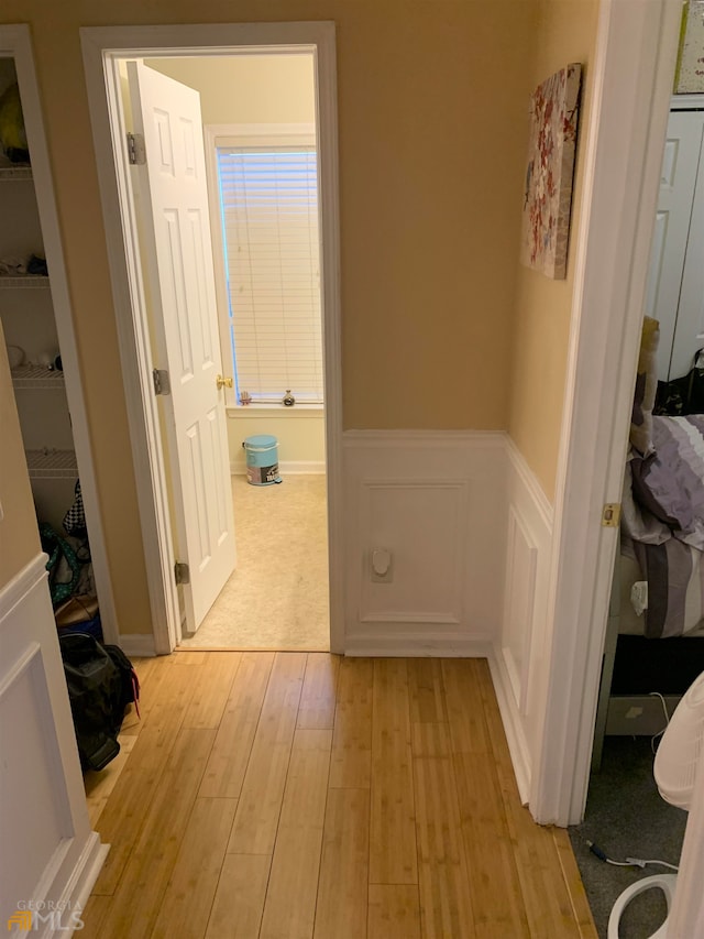 hallway with light hardwood / wood-style flooring