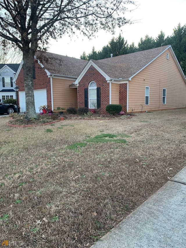 ranch-style house with a front yard and a garage