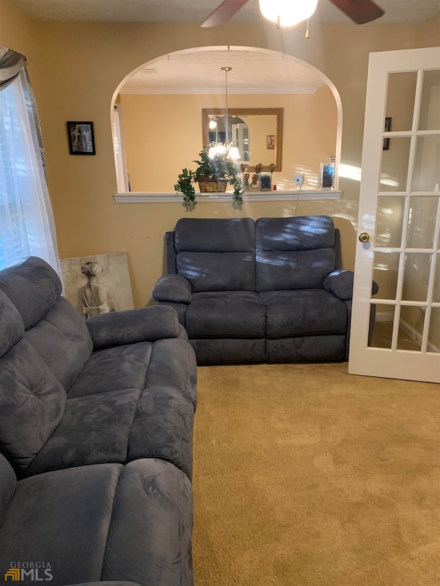 living room with carpet and ceiling fan with notable chandelier