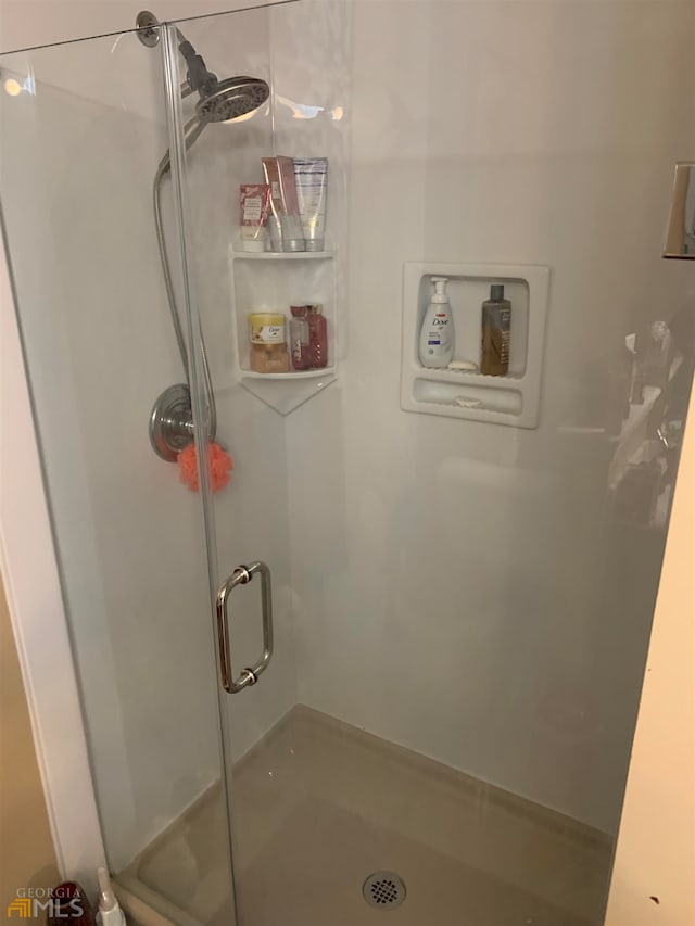 bathroom featuring a shower with shower door