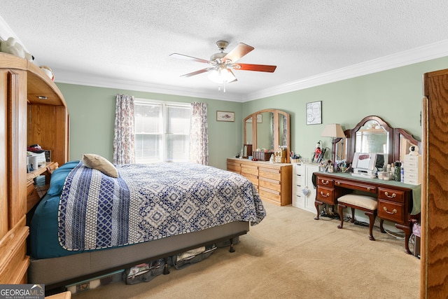 bedroom featuring ceiling fan, light carpet, ornamental molding, and a textured ceiling