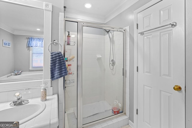 bathroom with sink, crown molding, and walk in shower