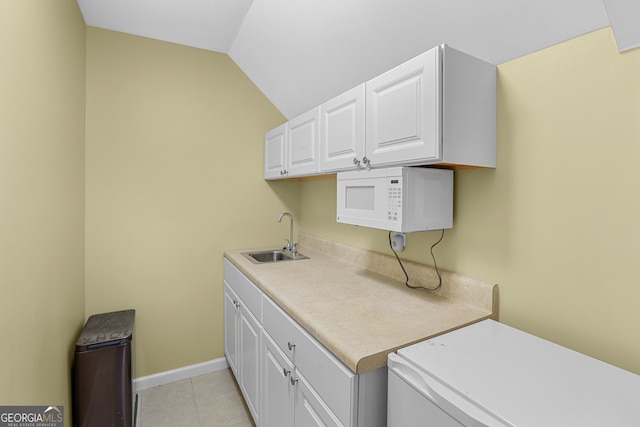 laundry room featuring light tile patterned flooring and sink