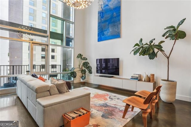 living room with a towering ceiling and an inviting chandelier