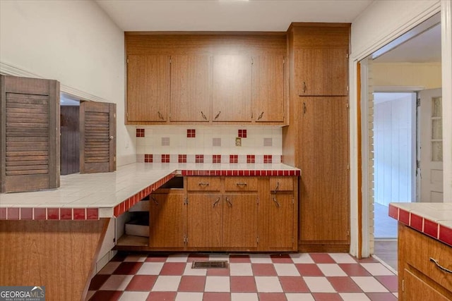 kitchen with tile countertops and backsplash