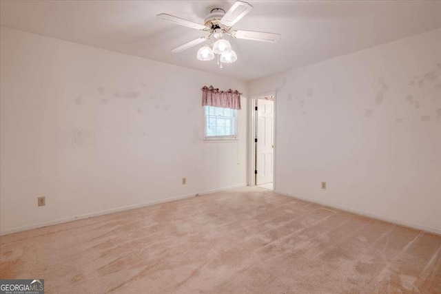 empty room with light colored carpet and ceiling fan