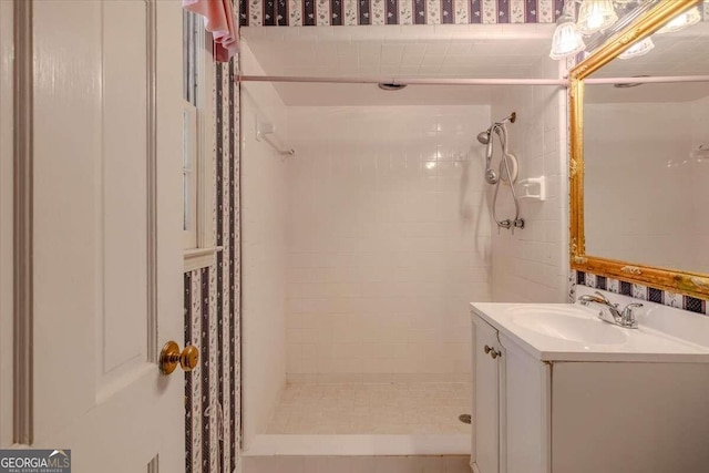 bathroom featuring vanity and a tile shower