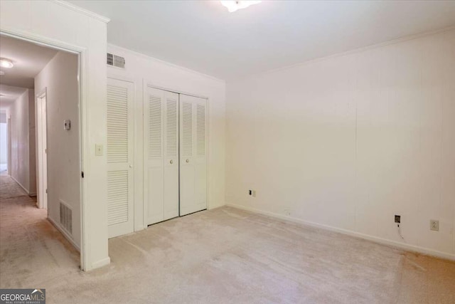 unfurnished bedroom featuring ornamental molding and light carpet