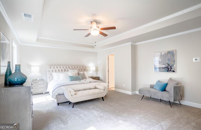 carpeted bedroom with ceiling fan, a raised ceiling, and crown molding