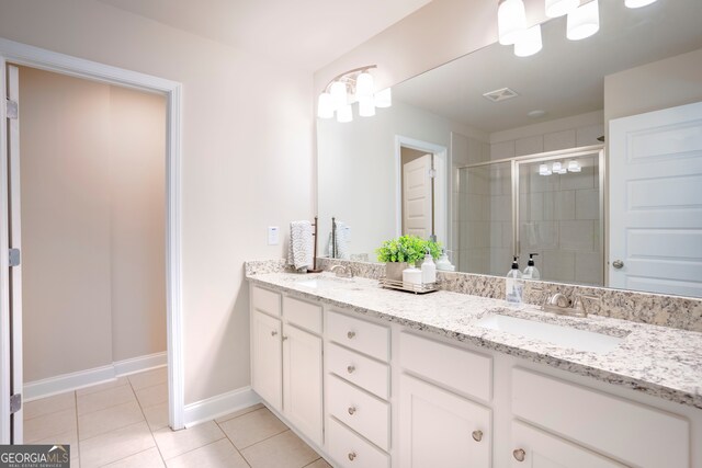 bathroom with vanity, walk in shower, and tile patterned flooring