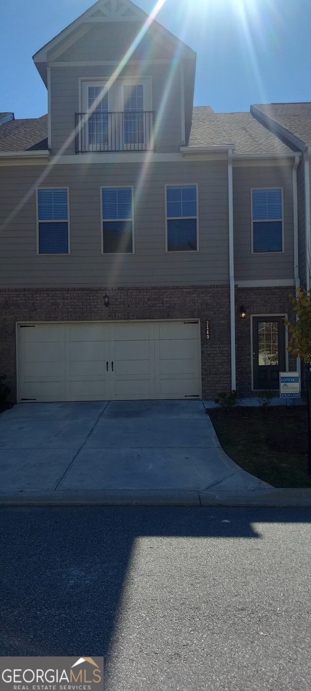 view of front of property with a garage and a balcony