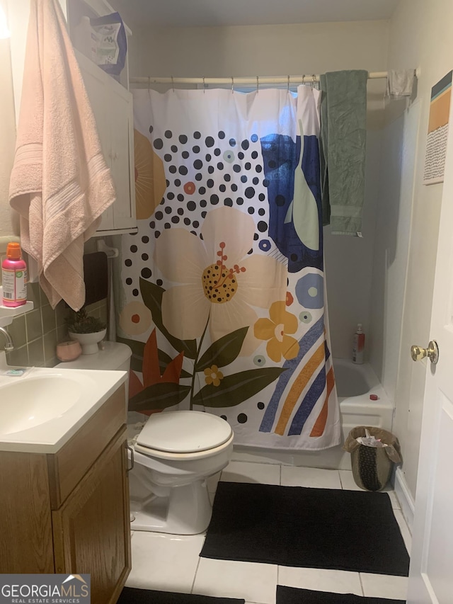 full bathroom featuring tile patterned floors, shower / bathtub combination with curtain, vanity, and toilet