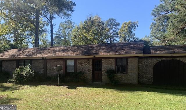 ranch-style home with a front lawn