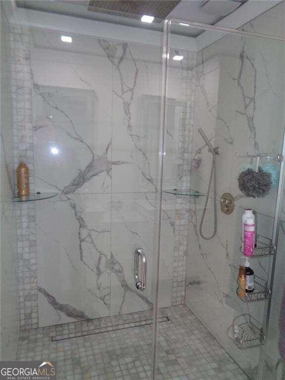 bathroom with a shower with shower door