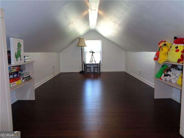 bonus room with dark hardwood / wood-style floors and vaulted ceiling