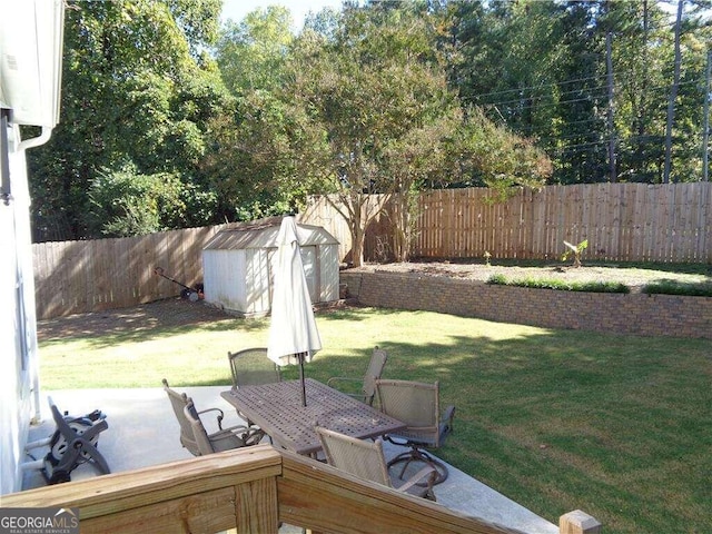 view of yard with a shed and a patio area