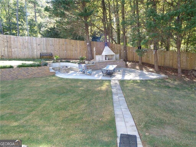 view of yard with a patio and an outdoor fire pit