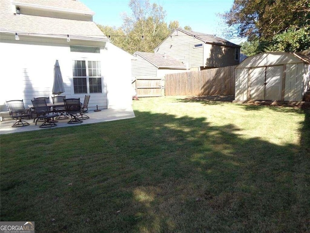 view of yard featuring a patio area and a storage shed