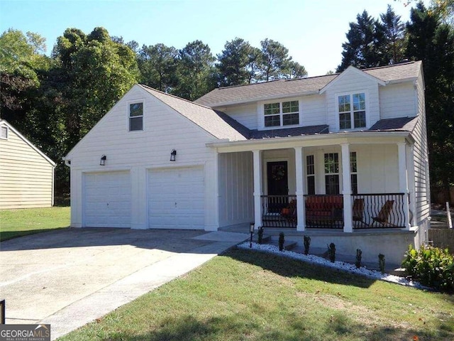 view of front of home with covered porch, a front lawn, and a garage