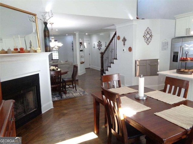 dining area with dark wood-type flooring and ornate columns