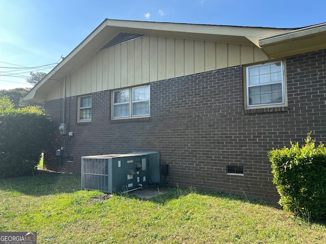 view of home's exterior featuring a yard and cooling unit