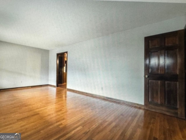 empty room with wood-type flooring