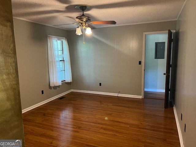 unfurnished room with dark wood-type flooring, ornamental molding, electric panel, a textured ceiling, and ceiling fan