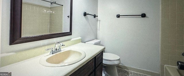 bathroom featuring toilet, vanity, and tile patterned flooring