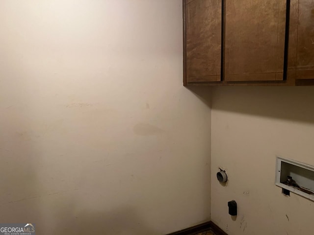 washroom with washer hookup and cabinets