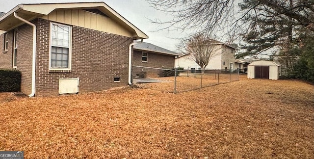 view of side of home with a storage shed