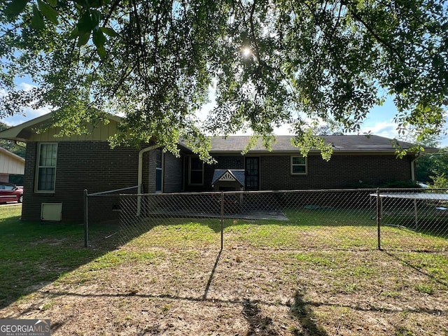 rear view of property with a lawn