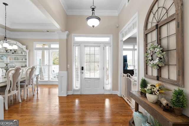 entryway with hardwood / wood-style floors and crown molding