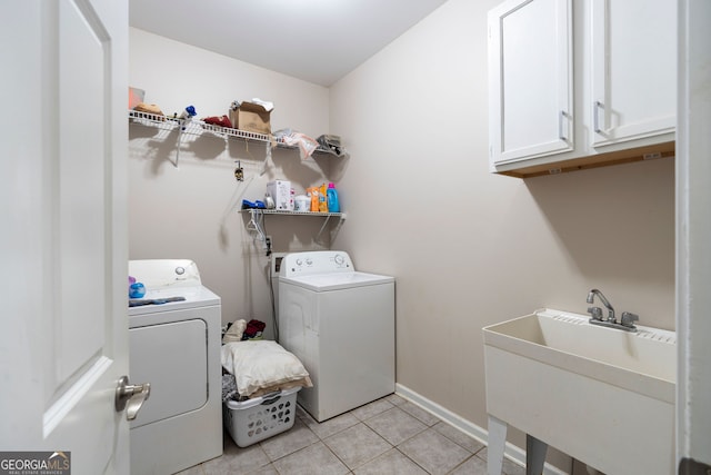 washroom featuring cabinets, independent washer and dryer, sink, and light tile patterned flooring