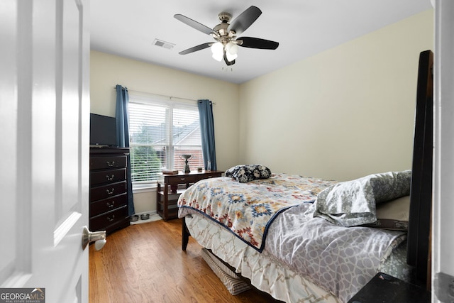 bedroom featuring hardwood / wood-style flooring and ceiling fan