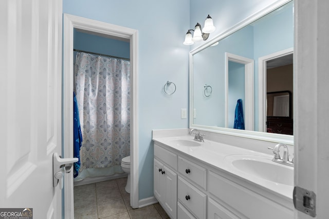 bathroom featuring tile patterned flooring, vanity, and toilet