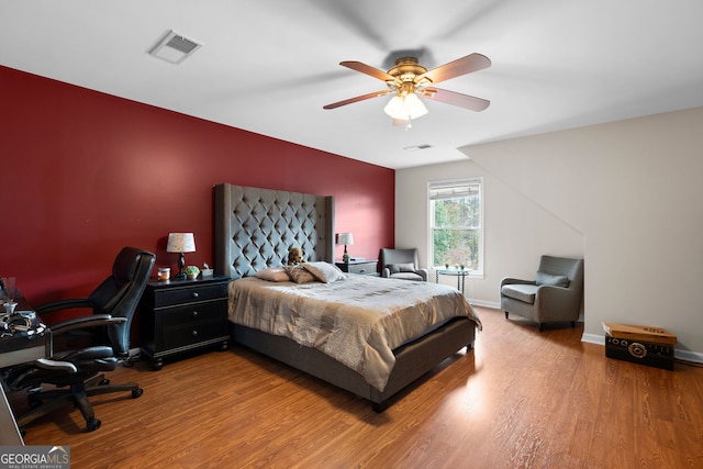 bedroom with ceiling fan and wood-type flooring