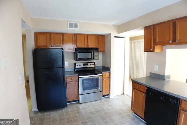 kitchen featuring a textured ceiling and black appliances