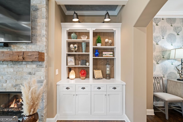 bar with ornamental molding, white cabinetry, and wood-type flooring