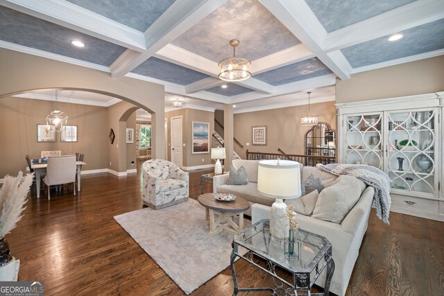 living room with crown molding, coffered ceiling, beamed ceiling, and dark hardwood / wood-style flooring