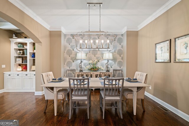 dining area with crown molding, an inviting chandelier, and dark hardwood / wood-style floors