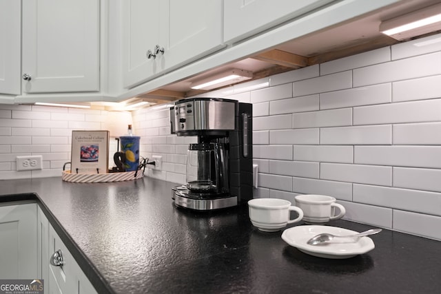 kitchen with decorative backsplash and white cabinetry