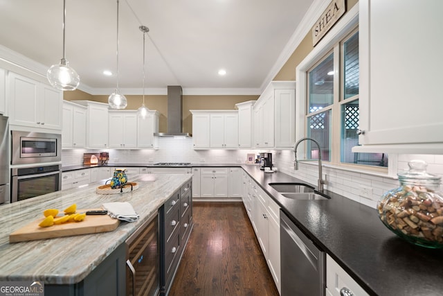 kitchen with stainless steel appliances, wall chimney exhaust hood, sink, and white cabinets