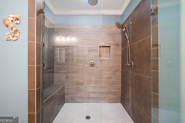 bathroom with ornamental molding and tiled shower