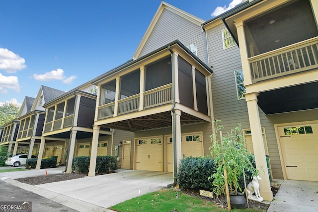 view of front of property with a garage and a sunroom