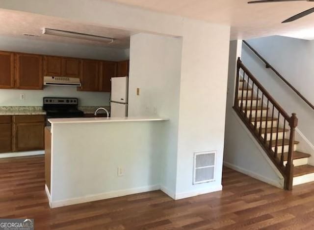 kitchen with black electric range oven, dark hardwood / wood-style floors, sink, and white refrigerator