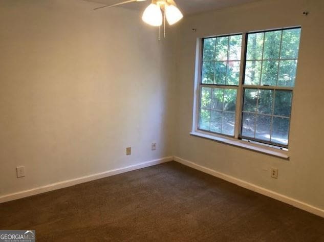 carpeted spare room with ceiling fan